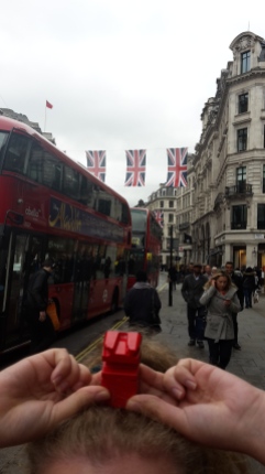 Abbie holding my red figure above her head so it is underneath the british flags
